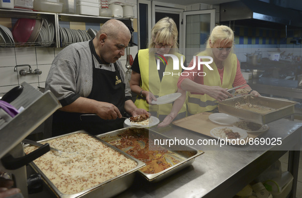 International volunteers from all artound the worl are preparing meals inside of the Aspa Boomerang Restaurant, as the owner Michael Pastrik...