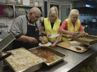 International volunteers from all artound the worl are preparing meals inside of the Aspa Boomerang Restaurant, as the owner Michael Pastrik...