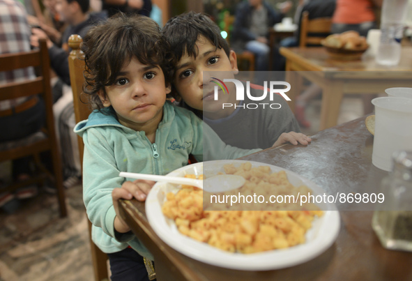 Children-refugees, Rokaya and her brother Karah from Iraq, during their dinner at the Aspa Boomerang Restaurant, as the owner Michael Pastri...