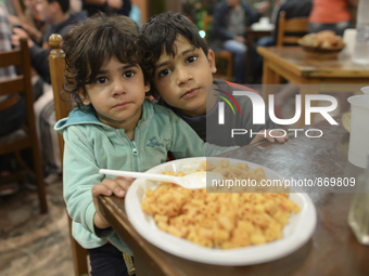 Children-refugees, Rokaya and her brother Karah from Iraq, during their dinner at the Aspa Boomerang Restaurant, as the owner Michael Pastri...
