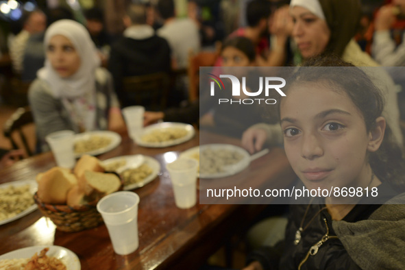 Members of a family from Syria having their evening meal together at the Aspa Boomerang Restaurant, as the owner Michael Pastrikos, helped b...