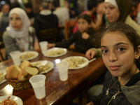 Members of a family from Syria having their evening meal together at the Aspa Boomerang Restaurant, as the owner Michael Pastrikos, helped b...