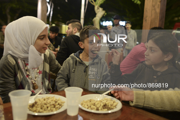 Members of a family from Syria having their evening meal together at the Aspa Boomerang Restaurant, as the owner Michael Pastrikos, helped b...