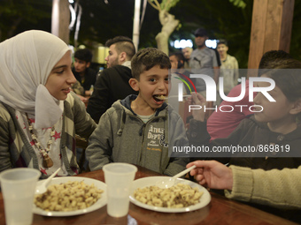 Members of a family from Syria having their evening meal together at the Aspa Boomerang Restaurant, as the owner Michael Pastrikos, helped b...