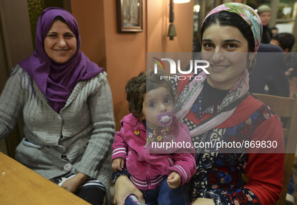 Halad from Syria with her daugther Elene  await for their evening meal at the Aspa Boomerang Restaurant, as the owner Michael Pastrikos, hel...