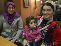 Halad from Syria with her daugther Elene  await for their evening meal at the Aspa Boomerang Restaurant, as the owner Michael Pastrikos, hel...