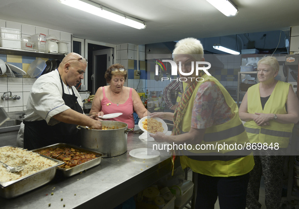 Volunteers from all over the world help at the Aspa Boomerang Restaurant, as the owner Michael Pastrikos, provides free meals for refugees a...