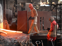 Laborers during work at a metal workshop at Postogola Area in Dhaka, Bangladesh on August 22, 2022.  (