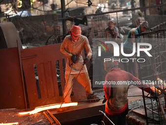 Laborers during work at a metal workshop at Postogola Area in Dhaka, Bangladesh on August 22, 2022.  (