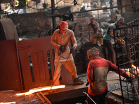 Laborers during work at a metal workshop at Postogola Area in Dhaka, Bangladesh on August 22, 2022.  (