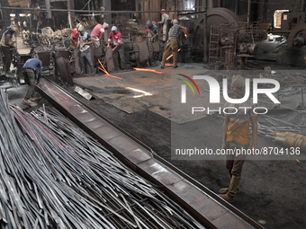 Laborers during work at a metal workshop at Postogola Area in Dhaka, Bangladesh on August 22, 2022.  (