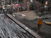 Laborers during work at a metal workshop at Postogola Area in Dhaka, Bangladesh on August 22, 2022.  (