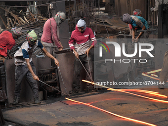 Laborers during work at a metal workshop at Postogola Area in Dhaka, Bangladesh on August 22, 2022.  (