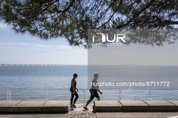 People are seen performing outdoor activities in the surroundings of the Tejo river promenade in Oriente. Lisbon, August 23, 2022. Portugal...