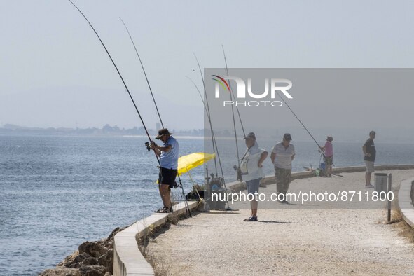 People are seen performing outdoor activities in the surroundings of the Tejo river promenade in Oriente. Lisbon, August 23, 2022. Portugal...