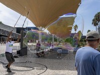 People are seen performing outdoor activities in the surroundings of the Tejo river promenade in Oriente. Lisbon, August 23, 2022. Portugal...