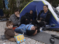 A family of migrants from Syria, in Kos camp, near the main Police station, as hundreds of new arrived migrants awaiting on a daily basis to...