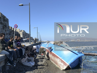 Migrants sitting in Kos harbour. Hundreds of new arrived migrants awaiting on a daily basis to be processed by the Greek police and given pa...