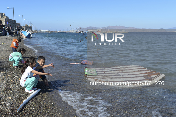 Children of migrants pictured playing in Kos harbour, as hundreds of new arrived migrants awaiting on a daily basis to be processed by the G...