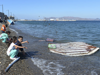 Children of migrants pictured playing in Kos harbour, as hundreds of new arrived migrants awaiting on a daily basis to be processed by the G...