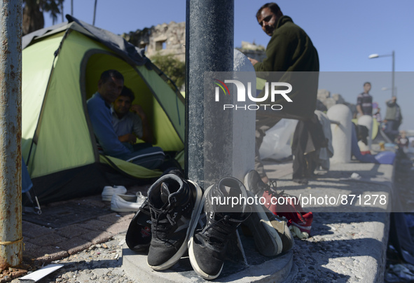 Migrants drying their shoes in Kos harbour when to be processed by the Greek police and given paperwork entitling them to leave the island....