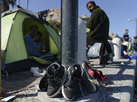 Migrants drying their shoes in Kos harbour when to be processed by the Greek police and given paperwork entitling them to leave the island....