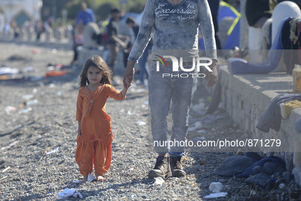 A young Fariba (age 3) from Afganistan, 
pictured in Kos harbour when her family awaiting to be processed by the Greek police and given pape...