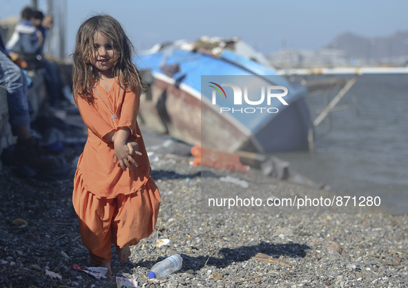 A young Fariba (age 3) from Afganistan, 
pictured in Kos harbour when her family awaiting to be processed by the Greek police and given pape...