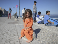 A young Fariba (age 3) from Afganistan, pictured in Kos harbour, as her family awaiting to be processed by the Greek police and given paperw...