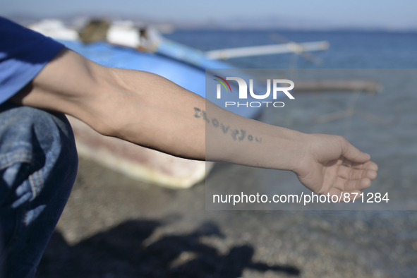 'ILOVEYOU' tatoo on a ram of a young migrant from Afganistan, pictured in Kos harbour, as awaiting to be processed by the Greek police and g...