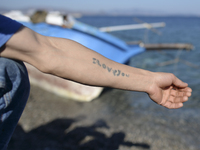 'ILOVEYOU' tatoo on a ram of a young migrant from Afganistan, pictured in Kos harbour, as awaiting to be processed by the Greek police and g...