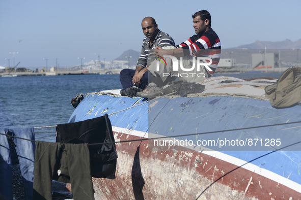 Migrants awaiting in Kos harbour to be processed by the Greek police and given paperwork entitling them to leave the island. 
Kos town, Kos...