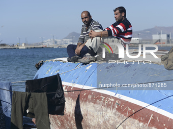 Migrants awaiting in Kos harbour to be processed by the Greek police and given paperwork entitling them to leave the island. 
Kos town, Kos...