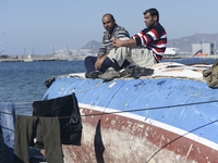 Migrants awaiting in Kos harbour to be processed by the Greek police and given paperwork entitling them to leave the island. 
Kos town, Kos...