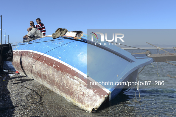 Migrants awaiting in Kos harbour to be processed by the Greek police and given paperwork entitling them to leave the island. 
Kos town, Kos...