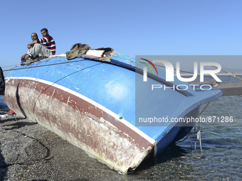 Migrants awaiting in Kos harbour to be processed by the Greek police and given paperwork entitling them to leave the island. 
Kos town, Kos...