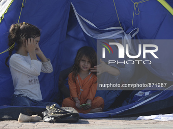 A young Fariba (age 3) from Afganistan, pictured in Kos harbour, as her family awaiting to be processed by the Greek police and given paperw...