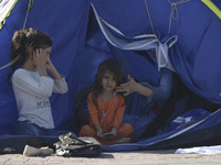 A young Fariba (age 3) from Afganistan, pictured in Kos harbour, as her family awaiting to be processed by the Greek police and given paperw...