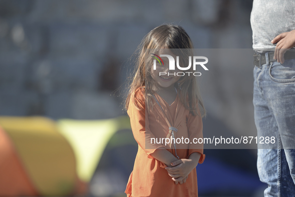 A young Fariba (age 3) from Afganistan pictured in Kos harbour, as her family awaiting to be processed by the Greek police and given paperwo...