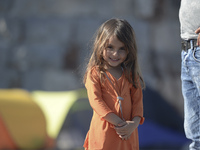 A young Fariba (age 3) from Afganistan pictured in Kos harbour, as her family awaiting to be processed by the Greek police and given paperwo...