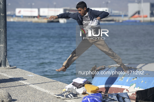 A migrant pictured in Kos harbour, as awaiting to be processed by the Greek police and given paperwork entitling them to leave the island....