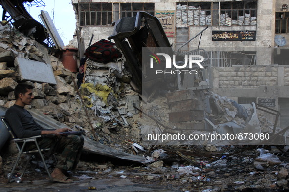 A fighter from the Free Syrian Army takes position following clashes with the pro-regime forces, in Bab al-hadid in the northern Syrian city...