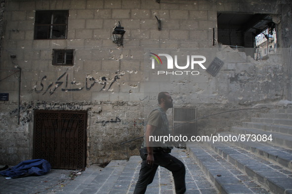 A fighter from the Free Syrian Army takes position following clashes with the pro-regime forces, in Bab al-hadid in the northern Syrian city...