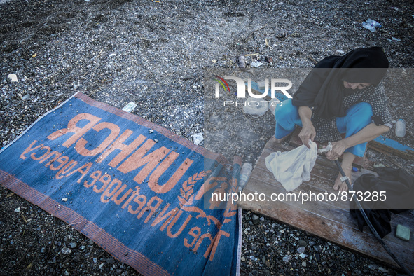 A woman wash her clothes in Kos, Greece, on October 27, 2015.More than 700,000 refugees and migrants have reached Europe's Mediterranean sho...