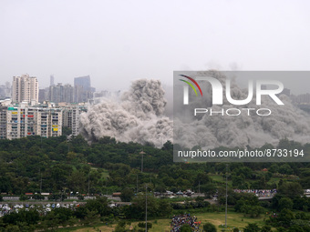 The Supertech Twin Towers collapse making a cloud of dust following a controlled demolition by explosion after the Supreme Court found them...