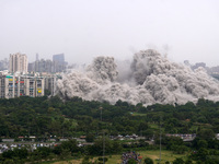 The Supertech Twin Towers collapse making a cloud of dust following a controlled demolition by explosion after the Supreme Court found them...