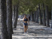 People are seen performing outdoor activities in the surroundings of the Tejo river promenade in Oriente. Lisbon, August 23, 2022. The manda...