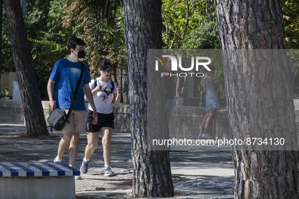 People are seen performing outdoor activities in the surroundings of the Tejo river promenade in Oriente. Lisbon, August 23, 2022. The manda...