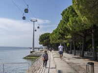 People are seen performing outdoor activities in the surroundings of the Tejo river promenade in Oriente. Lisbon, August 23, 2022. The manda...