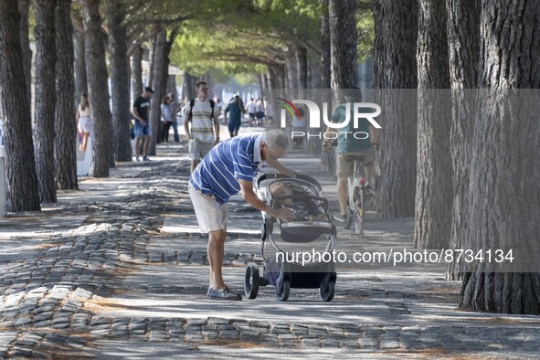 People are seen performing outdoor activities in the surroundings of the Tejo river promenade in Oriente. Lisbon, August 23, 2022. The manda...